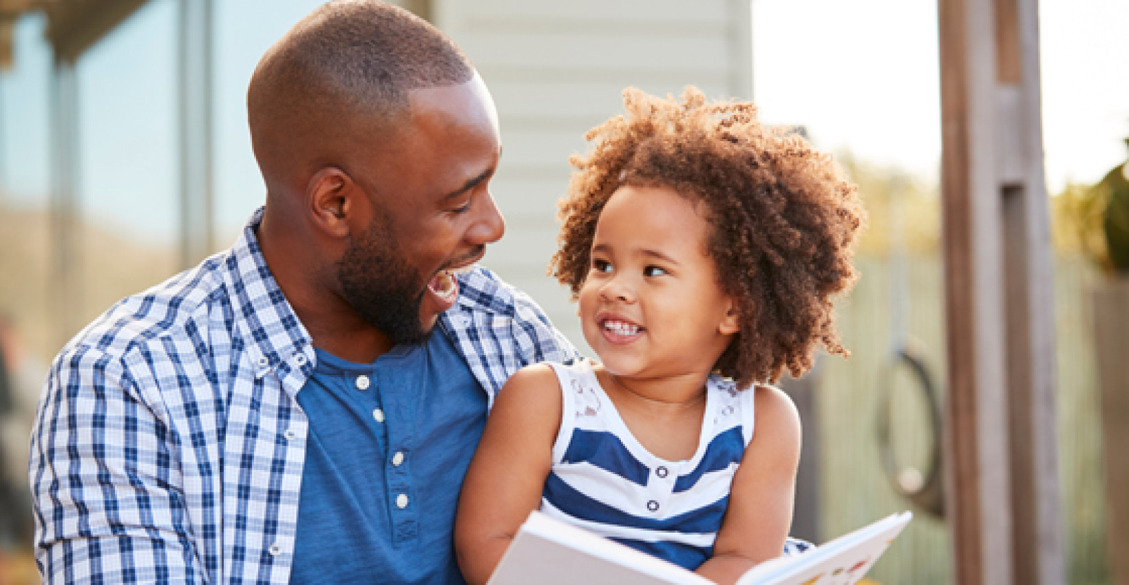 father and daughter smile together
