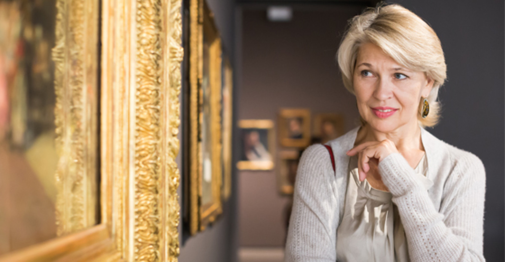 a woman views art that is likely expensive