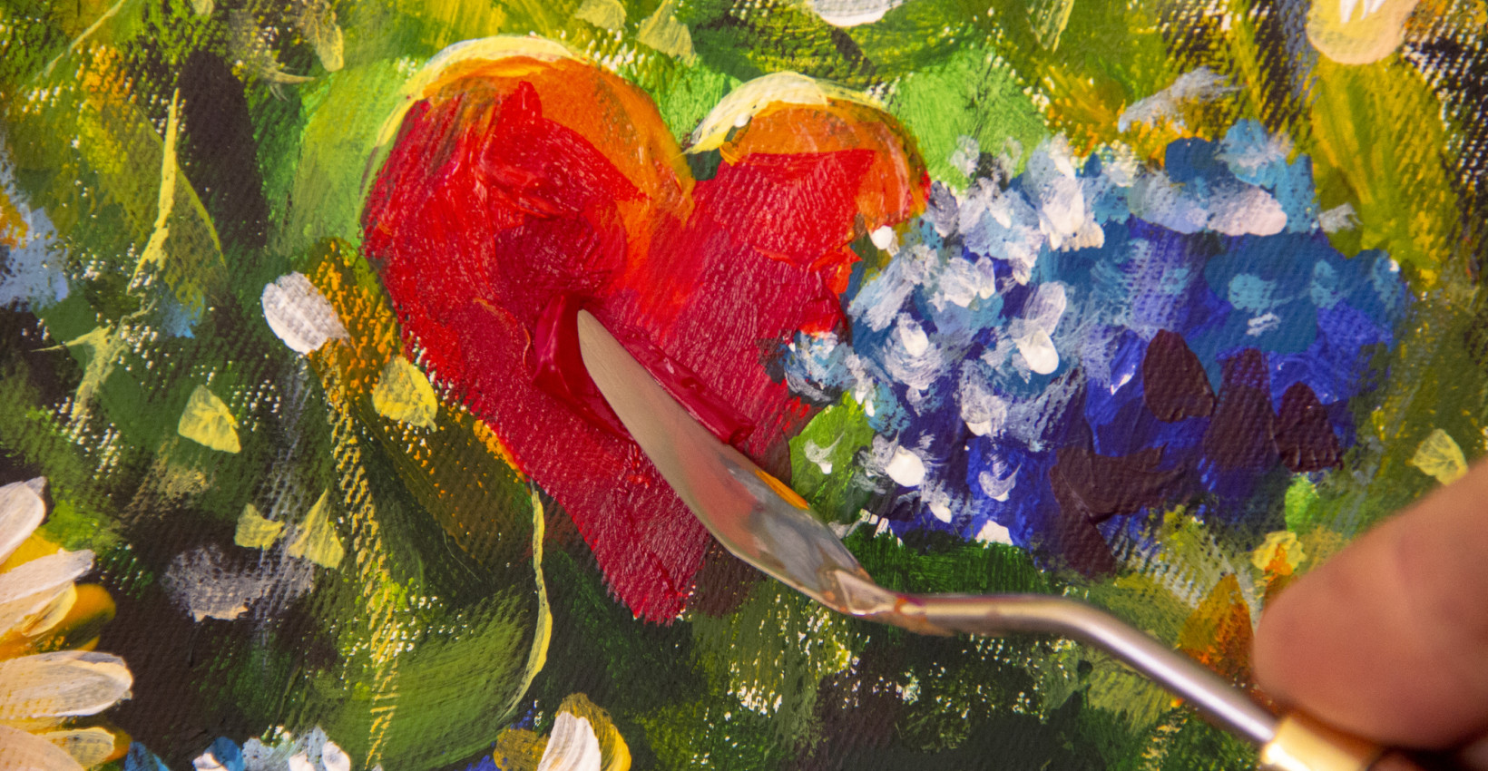 a piece of art that features a red heart and blue flowers with a pallet knife