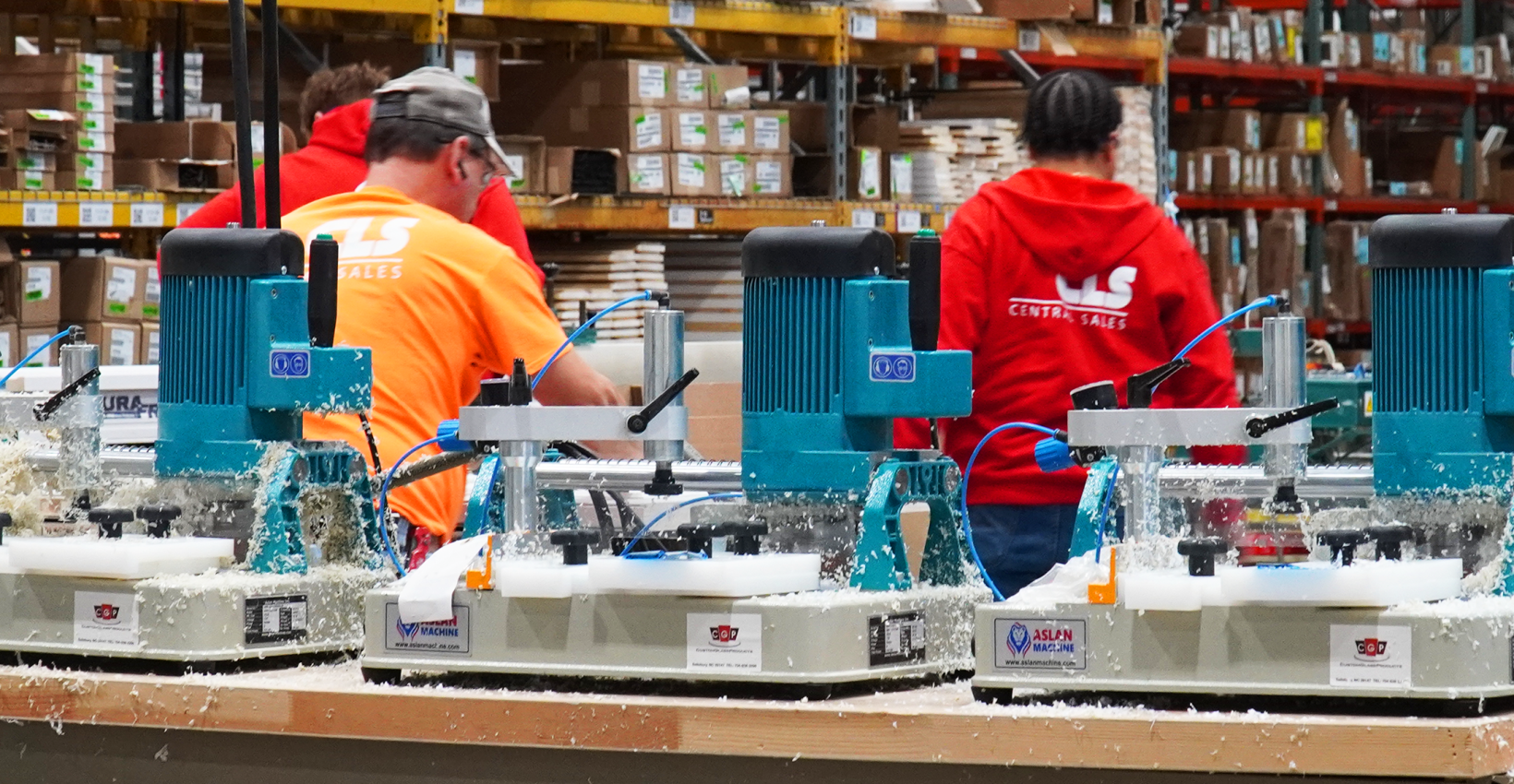 three people work inside central lumber sales