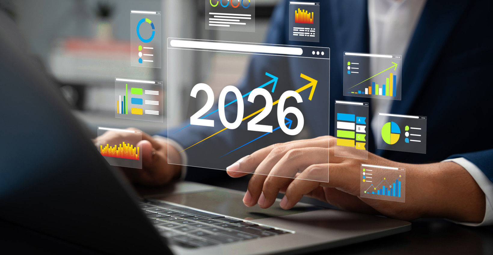 two people sit at a desk with a graphic overtop that says 2026