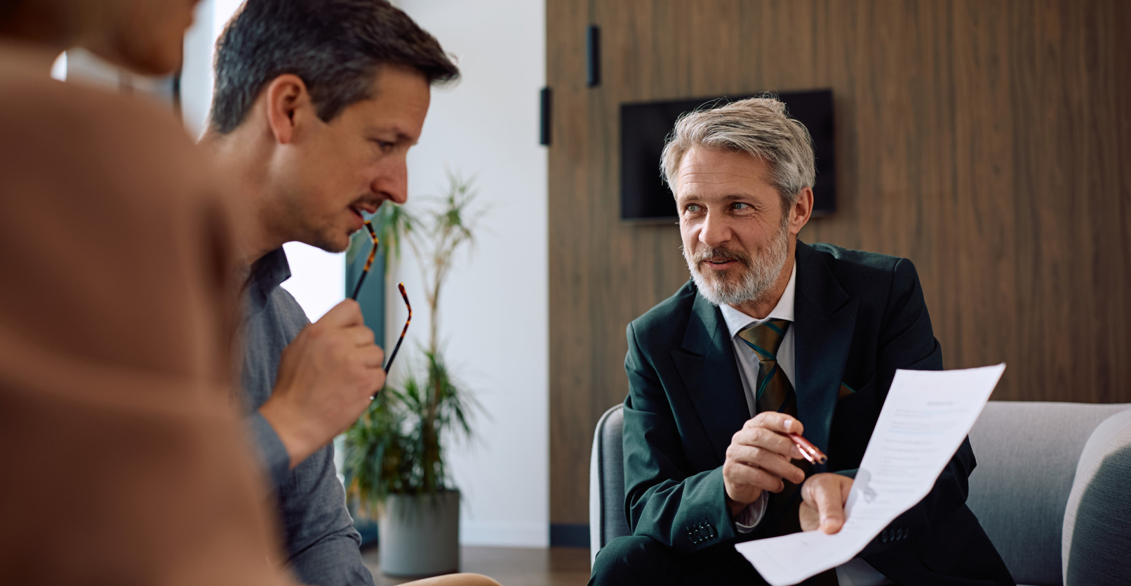 a man and woman talk to a professional businessman 