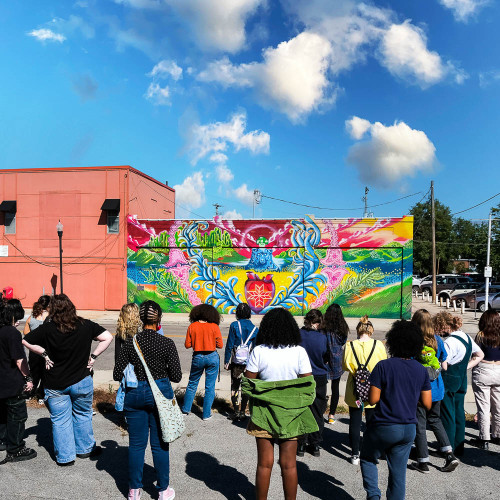 People looking at a mural. 