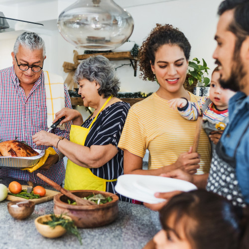 A family gathers in the kitchen for a meal