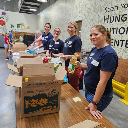 A group of UBT employees volunteering at a food bank