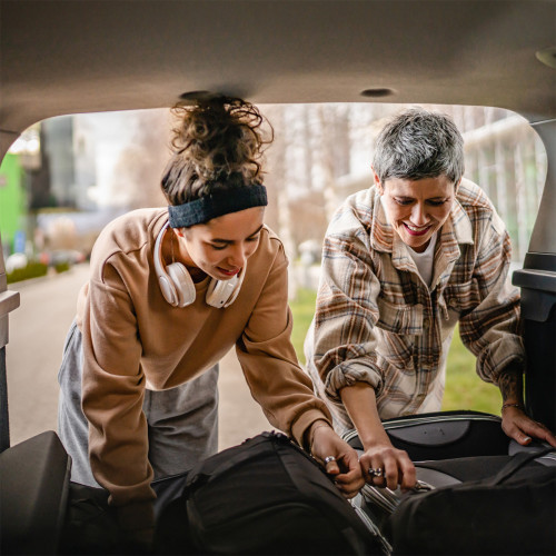 A dad helps his teenage daughter load up their car