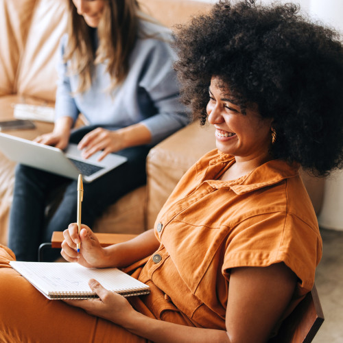 two women working together smiling