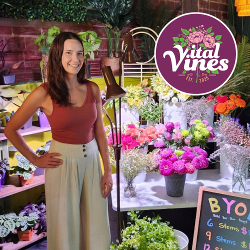 Sydney Vecchio stands in front of plants with vital vines logo overlayed