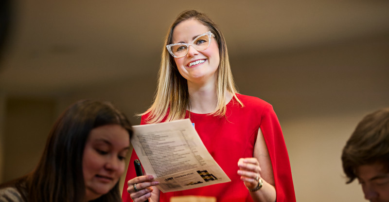 Brittany Planos smiling while holding a piece of paper