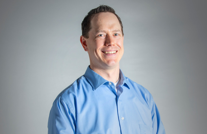 A headshot of John Rowe