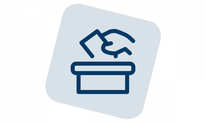 An illustration of a hand dropping a ballot into a ballot box