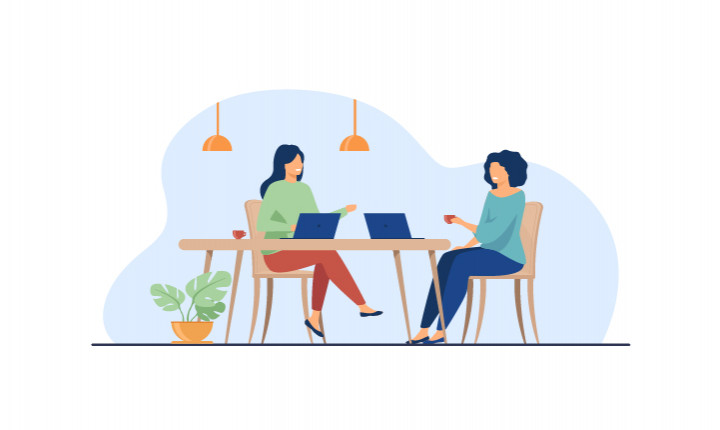 An illustration of two women sitting at a kitchen table working on their laptops