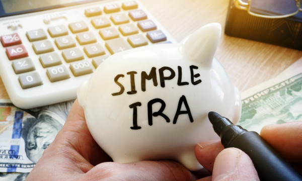 a white piggy with simple ira written in sharpie