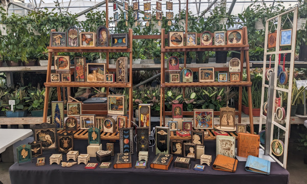 A collection of handmade wooden objects on sale at a vendor booth