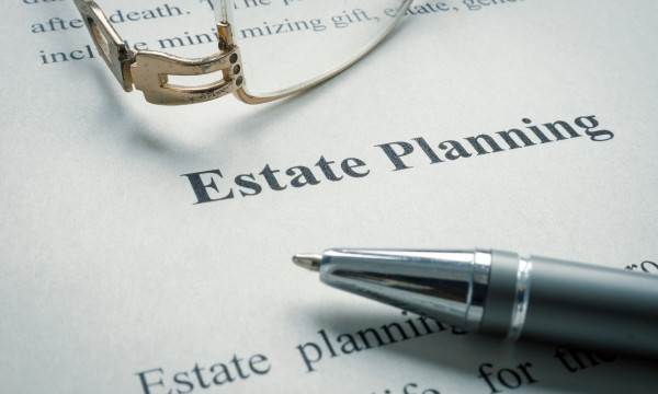 a pen next to a paper that says estate planning