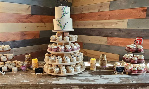 a table displaying cakes and desserts