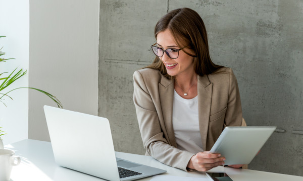 Woman at her computer reviewing the recent updates to the wealth management portal.